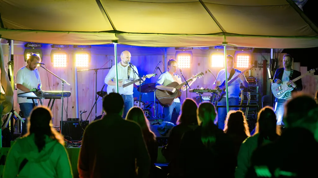 Band onder de tent, publiek ervoor, ’s avonds